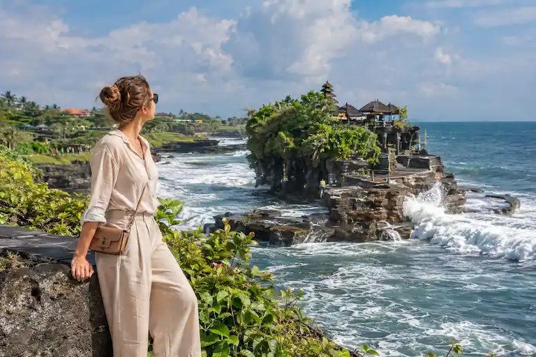 Woman Admiring a Coastal Sea Temple